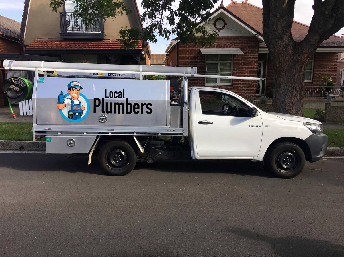 Plumber inspecting a pipe in Chatswood